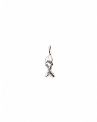 small  abstract sculptural sterling silver fish charm with small silver hoop on white background 
